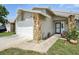 Charming home with a two-car garage and stone accents. Manicured lawn and welcoming entrance create curb appeal at 920 N Lakewood Ter, Port Orange, FL 32127