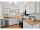 Kitchen with stainless steel appliances, wood countertops, and bright white cabinetry at 920 N Lakewood Ter, Port Orange, FL 32127