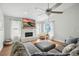 Bright living room features a stone fireplace, ceiling fan, and hardwood floors for a comfortable and stylish space at 920 N Lakewood Ter, Port Orange, FL 32127