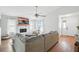 Open-concept living room with a stone fireplace, hardwood floors, and neutral decor at 920 N Lakewood Ter, Port Orange, FL 32127