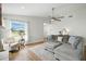Bright living room featuring a comfortable sectional sofa, hardwood floors, and a large window at 920 N Lakewood Ter, Port Orange, FL 32127