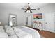 Bright bedroom featuring modern furnishings, ceiling fan, and a large wall-mounted TV at 920 N Lakewood Ter, Port Orange, FL 32127