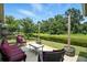 Relaxing patio area overlooking a tranquil canal, furnished with comfortable seating and lush greenery, perfect for outdoor living at 920 N Lakewood Ter, Port Orange, FL 32127