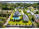 Aerial view of a home featuring a pool, detached garage, manicured lawn and a view of the bay at 96 Grove St, Ormond Beach, FL 32174