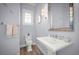 Powder room featuring blue-grey paint, a pedestal sink, classic fixtures, and a decorative mirror at 96 Grove St, Ormond Beach, FL 32174