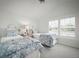 Neutral bedroom featuring two beds with patterned bedding and a window for natural light at 96 Grove St, Ormond Beach, FL 32174