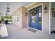 Charming entryway featuring a beautiful blue door and welcoming porch with stylish lanterns at 96 Grove St, Ormond Beach, FL 32174
