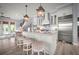 Bright kitchen features pendant lights, marble countertops, an island with seating, and stainless steel appliances at 96 Grove St, Ormond Beach, FL 32174