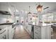 Gourmet kitchen with stainless steel appliances, a large island, and elegant lighting fixtures at 96 Grove St, Ormond Beach, FL 32174
