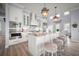 Bright kitchen features pendant lights, marble countertops, an island with seating, and stainless steel appliances at 96 Grove St, Ormond Beach, FL 32174
