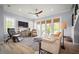 Cozy living room with a ceiling fan, plush furniture, large windows, and access to the outdoors at 96 Grove St, Ormond Beach, FL 32174