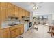 Efficient kitchen featuring light-colored cabinets, tile floor, modern appliances, and view to living area at 1 Beechwood Dr, Ormond Beach, FL 32176