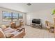 Cozy living room featuring natural light, tile floors, comfortable seating, and a small dining area at 1 Beechwood Dr, Ormond Beach, FL 32176