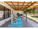 Inviting outdoor living space with a covered patio, comfortable seating, and lush greenery at 1 Beechwood Dr, Ormond Beach, FL 32176