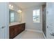 Bathroom features double sinks with warm toned vanity, quartz countertop, and a separate glass shower at 9762 Neruda St, Orlando, FL 32827