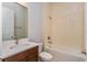Bathroom with a wood vanity and shower-tub combination at 9762 Neruda St, Orlando, FL 32827