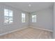 Bright bedroom with three windows and neutral carpet at 9762 Neruda St, Orlando, FL 32827