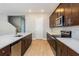 Modern kitchen features stainless steel appliances, stylish cabinetry, and quartz countertops, perfect for cooking and entertaining at 9762 Neruda St, Orlando, FL 32827