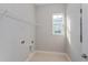 A laundry room with tile flooring and utility connections at 9762 Neruda St, Orlando, FL 32827