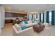 Bright open-concept living room with recessed lighting, comfortable seating, and a dining area at 9762 Neruda St, Orlando, FL 32827