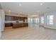 Bright open-concept living room features recessed lighting, smooth walls, and stunning light wood floors at 9762 Neruda St, Orlando, FL 32827