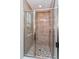 Glass shower with dual showerheads and mosaic tile floor at 9762 Neruda St, Orlando, FL 32827