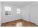 Bright bedroom featuring wood-look floors and a door at 10185 Pearson Ave, Orlando, FL 32827