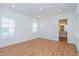 Spacious bedroom with wood-look flooring and two windows at 10185 Pearson Ave, Orlando, FL 32827