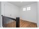 Upstairs bedroom with wood floors and two windows at 10185 Pearson Ave, Orlando, FL 32827