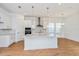 Modern kitchen with white cabinets, quartz countertops, and island at 10185 Pearson St, Orlando, FL 32827