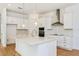 Modern kitchen with white cabinets, quartz countertops, and island at 10185 Pearson Ave, Orlando, FL 32827