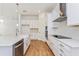 Modern kitchen with white cabinets, quartz countertops, and island at 10185 Pearson Ave, Orlando, FL 32827