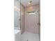 Walk-in shower with neutral tile and a window for natural light at 10185 Pearson Ave, Orlando, FL 32827