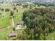 Aerial view of property boundaries, showcasing open fields and wooded areas, including outbuildings at 1951 Nw 114Th Loop, Ocala, FL 34475