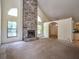 Spacious living room featuring a stone fireplace, vaulted ceilings, and natural light from large windows at 1951 Nw 114Th Loop, Ocala, FL 34475