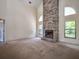 Bright living room with a stone fireplace and ample natural light from large windows at 1951 Nw 114Th Loop, Ocala, FL 34475