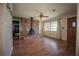 Living room boasting brick fireplace, ceiling fan, hardwood floors and natural light at 9701 E Warm Springs Ave, Coleman, FL 33521