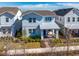 Two-story light blue house with metal roof, front porch, and landscaped yard at 13438 Leggett Aly, Orlando, FL 32827
