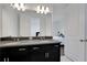Bathroom with double vanity, dark brown cabinets and gray countertop at 13438 Leggett Aly, Orlando, FL 32827