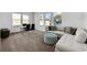 Bright bonus room features a cozy sectional sofa and a workspace with a table and chairs at 13438 Leggett Aly, Orlando, FL 32827