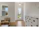 Bright entryway with white storage cabinet and view to backyard through a glass door at 13438 Leggett Aly, Orlando, FL 32827