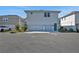 Two-car garage with light gray doors and teal accents at 13438 Leggett Aly, Orlando, FL 32827