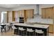Modern kitchen with island, stainless steel appliances, and light wood cabinets at 13438 Leggett Aly, Orlando, FL 32827