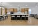 Spacious kitchen with island, stainless steel appliances, and light wood cabinets at 13438 Leggett Aly, Orlando, FL 32827