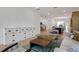 Open living room with two coffee tables and a view of the kitchen and staircase at 13438 Leggett Aly, Orlando, FL 32827