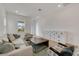 Spacious living room with light beige couch, wooden coffee table, and white storage cabinet at 13438 Leggett Aly, Orlando, FL 32827