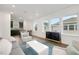Open concept living room with a grey couch and dark wood cabinet at 13438 Leggett Aly, Orlando, FL 32827