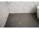 Dark hexagon tile shower floor in a modern bathroom at 13438 Leggett Aly, Orlando, FL 32827