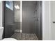 Large walk-in shower with gray tile and pebble floor at 13438 Leggett Aly, Orlando, FL 32827
