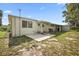 View of the home's exterior, showcasing the backyard and landscaping at 2734 Vindale Rd, Tavares, FL 32778